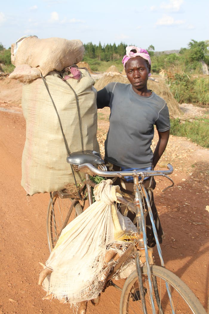 A Woman Holding Sacks of Harvested Root Crops